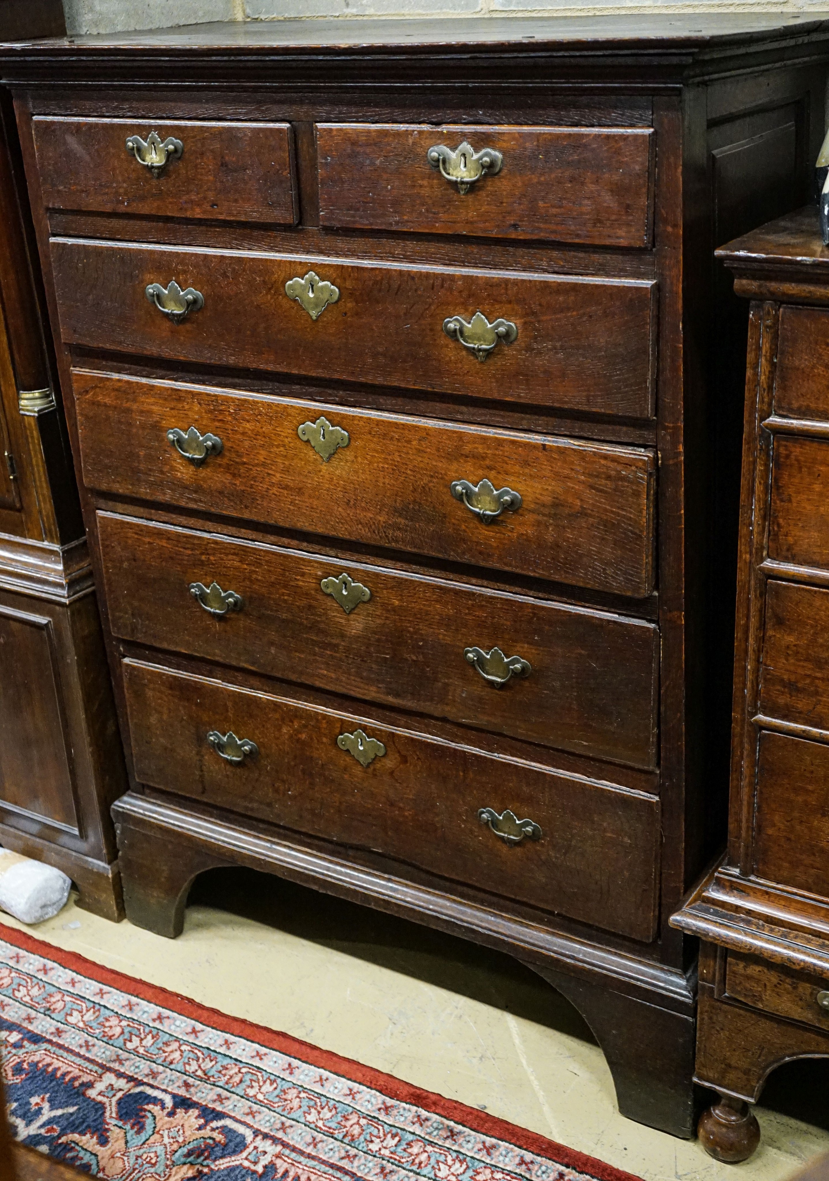A George III oak chest of two short and four long drawers, on bracket feet, width 102cm, depth 56cm, height 136cm